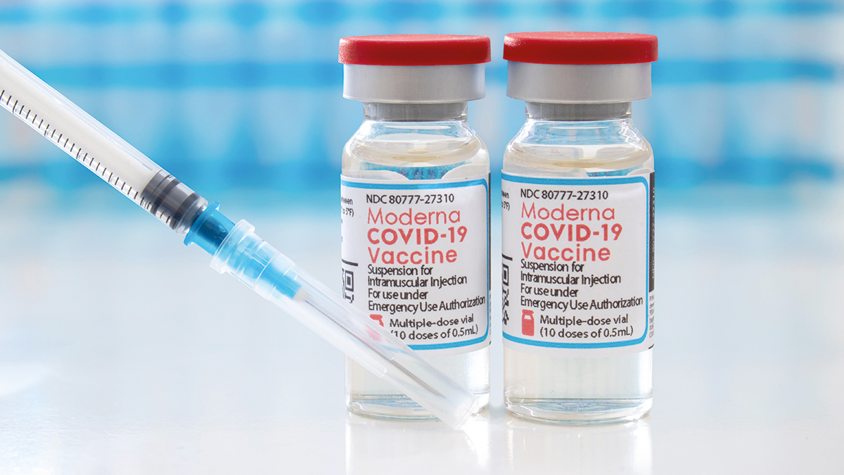 Calgary, Alberta, Canada. April 7, 2021. A couple of Moderna dosis of Covid-19 vaccines on vial bottles and an injection syringe.
